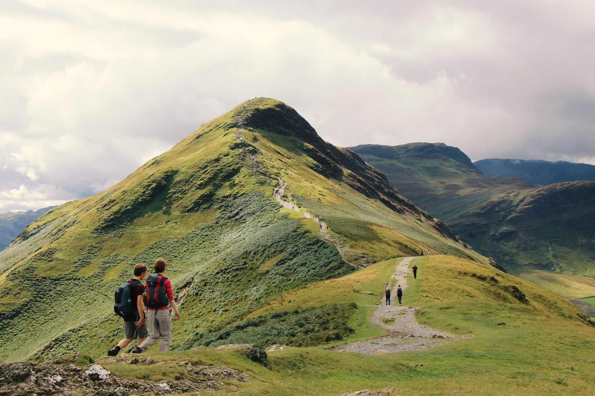 Hikers on a ridge above a UK valley
